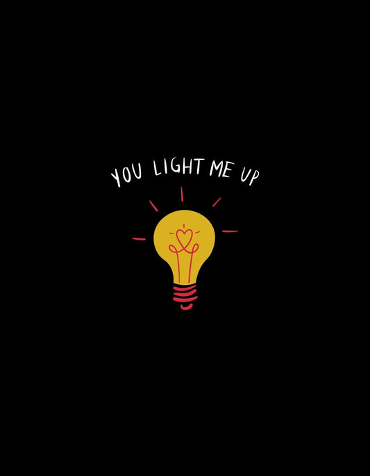 Egy aranyos és melegséget árasztó villanykörtét ábrázol a kép, ami egy szívvel van díszítve, és a "You light me up" felirattal kiegészítve. 
