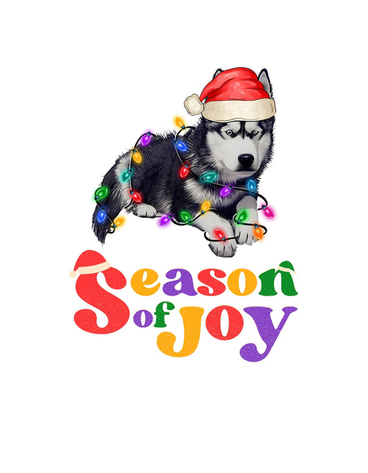 Egy ünnepi hangulatú szibériai husky kölyök látható, fején mikulássapkával, színes karácsonyi fényekkel körbevéve. Az "Season of Joy" szöveg alatta kedves, ünnepi betűtípussal kiemeli a vidám hangulatot. 